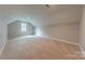 Spacious bonus room features neutral carpeting, window, and sloped ceilings at 10101 Woodview Cir, Charlotte, NC 28277