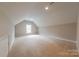 Bonus room featuring neutral carpeting, window, and sloped ceilings at 10101 Woodview Cir, Charlotte, NC 28277