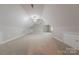 Finished bonus room offers neutral carpet, angled ceilings, and plentiful storage access at 10101 Woodview Cir, Charlotte, NC 28277