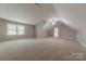 Spacious bonus room featuring neutral carpet and abundant natural light from multiple windows at 10101 Woodview Cir, Charlotte, NC 28277