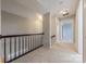 Upstairs hallway featuring neutral carpet and freshly painted walls and trim at 10101 Woodview Cir, Charlotte, NC 28277