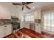 Well-equipped kitchen with stainless appliances, granite counters, and a large window overlooking the outdoor scenery at 10101 Woodview Cir, Charlotte, NC 28277
