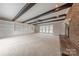 Inviting living area featuring exposed beams, built-in shelves, and a cozy brick fireplace at 10101 Woodview Cir, Charlotte, NC 28277