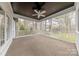 Screened porch with white railings, ceiling fan and views of the backyard at 10101 Woodview Cir, Charlotte, NC 28277