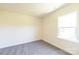An empty room with soft, neutral walls, large window, and carpeted floor at 104 Kentmore Dr, Waxhaw, NC 28173