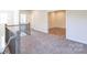 Hallway with wood staircase, carpeted floor, and an open doorway to a room at 104 Kentmore Dr, Waxhaw, NC 28173