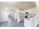 Modern kitchen with white cabinetry, granite countertops, stainless steel appliances, and access to the staircase at 104 Kentmore Dr, Waxhaw, NC 28173