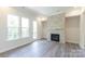 Bright living room featuring a fireplace, two large windows, and a glass panel door at 104 Kentmore Dr, Waxhaw, NC 28173