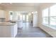 Bright and open living space with wood-look floors, kitchen island, and a fireplace at 104 Kentmore Dr, Waxhaw, NC 28173