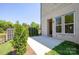A lovely patio with a brick house exterior, and pretty privacy trees at 104 Kentmore Dr, Waxhaw, NC 28173