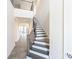 Bright foyer with dark-tread staircase and iron railing leading to the upper level at 104 Kentmore Dr, Waxhaw, NC 28173