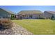 Backyard with a lush lawn, open patio with seating, and mature landscaping at 11124 Chapeclane Rd, Charlotte, NC 28278