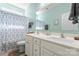 Bright bathroom featuring a double vanity, coordinating shower curtain, and ample lighting at 11124 Chapeclane Rd, Charlotte, NC 28278