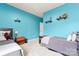 Well-lit bedroom with twin beds, blue walls, and neutral carpet flooring at 11124 Chapeclane Rd, Charlotte, NC 28278