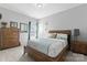 Cozy bedroom with a wooden bed frame, carpeted floors and a chest of drawers at 11124 Chapeclane Rd, Charlotte, NC 28278