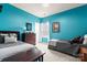 Bright bedroom with twin beds, a blue accent wall, and neutral-toned carpet at 11124 Chapeclane Rd, Charlotte, NC 28278