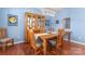 Traditional dining room features wooden table set, hutch, and modern chandelier with beautiful wood floors at 11124 Chapeclane Rd, Charlotte, NC 28278