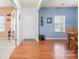 Bright entryway with hardwood floors, an open layout, and a glimpse of a dining area at 11124 Chapeclane Rd, Charlotte, NC 28278