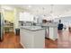 Bright eat-in kitchen features white cabinets, stainless steel appliances, granite counters, and a kitchen island at 11124 Chapeclane Rd, Charlotte, NC 28278