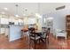 Eat-in kitchen features white cabinets, stainless steel appliances, granite counters, and an attached dining area at 11124 Chapeclane Rd, Charlotte, NC 28278