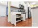 Bright eat-in kitchen features white cabinets, stainless steel appliances, granite counters, and convenient pull out drawers at 11124 Chapeclane Rd, Charlotte, NC 28278