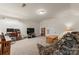 Spacious living room featuring neutral carpet, a TV, and a comfortable seating area at 11124 Chapeclane Rd, Charlotte, NC 28278