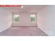 Bright bedroom featuring two windows, neutral carpet, and ample natural light at 11220 Cardinal Creek Ave, Charlotte, NC 28215