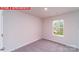 Cozy bedroom with plush carpeting, a window providing natural light, and a fresh, neutral color palette at 11220 Cardinal Creek Ave, Charlotte, NC 28215