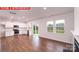Open-concept living area with wood flooring, a kitchen, and sliding glass doors to the backyard at 11220 Cardinal Creek Ave, Charlotte, NC 28215