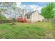 Spacious backyard with a well-maintained lawn, wooden fence, and a chimney, ideal for outdoor activities at 11404 Larix Dr, Charlotte, NC 28273