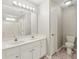 Bright bathroom features a double sink vanity with a large mirror and a combination tub and shower at 11404 Larix Dr, Charlotte, NC 28273