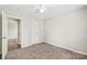 This bedroom offers carpet floors, a ceiling fan, and access to a closet and ensuite bath at 11404 Larix Dr, Charlotte, NC 28273
