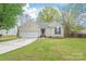 Charming single-story home featuring a well-manicured lawn and an attached two-car garage at 11404 Larix Dr, Charlotte, NC 28273