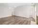 Open-concept living room featuring hardwood floors, neutral paint, and access to other rooms at 11404 Larix Dr, Charlotte, NC 28273