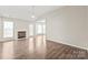 Spacious living room with a fireplace, fan, hardwood floors, and a bay window area at 11404 Larix Dr, Charlotte, NC 28273