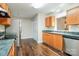 Modern kitchen equipped with stainless steel appliances, wooden cabinets, and dark countertops at 1212 Shenandoah Cir, Rock Hill, SC 29730