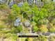 Aerial view of the property showcasing mature trees, a well-maintained lawn, and a private backyard at 12228 Plover Dr, Charlotte, NC 28269