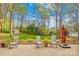 Enjoy the beautiful backyard with stone patio and outdoor seating, perfect for relaxation at 12228 Plover Dr, Charlotte, NC 28269