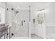 Modern bathroom with a glass shower, white cabinets, and a marble tiled floor at 12228 Plover Dr, Charlotte, NC 28269