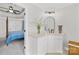 Clean bathroom featuring white cabinets, a marble sink, and an oval mirror at 12228 Plover Dr, Charlotte, NC 28269