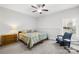 Bedroom featuring a bed, chair, dresser, and a large window for natural light at 12228 Plover Dr, Charlotte, NC 28269