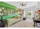 Bright bedroom features a unique green wall with creative decorations and plush seating area at 12228 Plover Dr, Charlotte, NC 28269