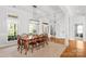 Spacious dining room with wood table and chairs, light fixture, and access to the foyer at 12228 Plover Dr, Charlotte, NC 28269