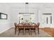 Well-lit dining area showcases a wood table, seating for eight, and large windows at 12228 Plover Dr, Charlotte, NC 28269