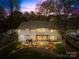 Expansive backyard with well-maintained lawn, patio, and landscaping as seen from home's exterior at 12228 Plover Dr, Charlotte, NC 28269
