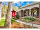 Inviting front exterior with a covered porch, classic columns, and lush landscaping at 12228 Plover Dr, Charlotte, NC 28269