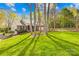 Well-maintained home with a lush lawn, mature trees, and a classic brick facade at 12228 Plover Dr, Charlotte, NC 28269
