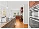 Bright kitchen with wood floors, stainless double ovens, and stylish cabinetry details at 12228 Plover Dr, Charlotte, NC 28269