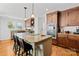 Gourmet kitchen featuring a large island with seating and stone countertops at 12228 Plover Dr, Charlotte, NC 28269