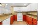 Kitchen with red and white cabinets, granite countertops, and modern appliances at 12228 Plover Dr, Charlotte, NC 28269